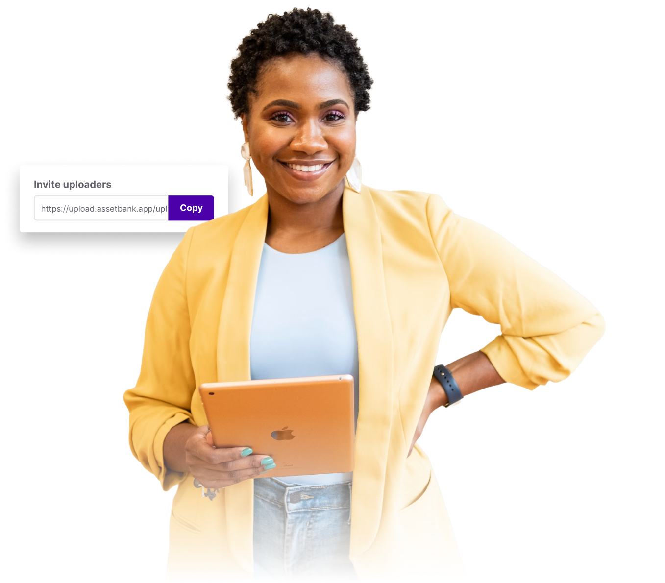 Asset Bank vs Brandfolder – lady in yellow jacket smiling to camera. She is holding an orange tablet.