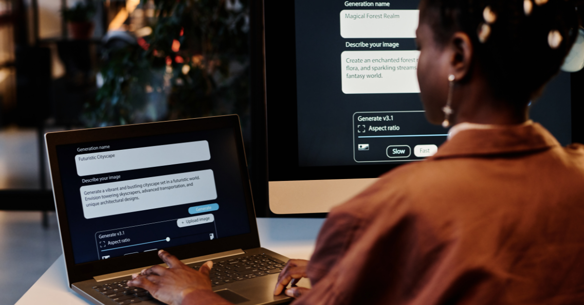 A lady is on her laptop prompting AI features to create an image. There is a larger monitor to the right of her. She has short dark hair and is wearing a deep orange satin shirt. We are looking over her shoulder.